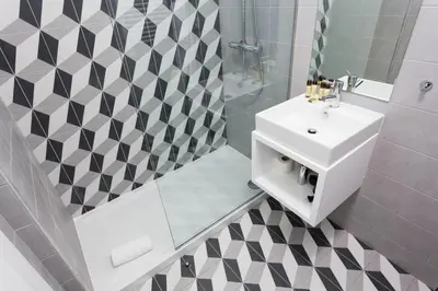 a bathroom with a white sink and a shower at Oporto City View - Santo Ildefonso in Porto