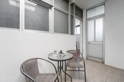 a table and chairs in a room with windows at GuestReady - Beautiful Plateau in Porto