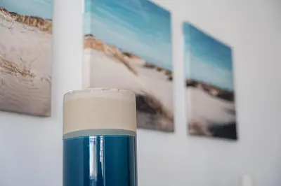 a blue and white candle in front of some pictures at GuestReady - Beautiful Plateau in Porto