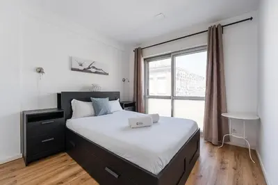 a bedroom with a bed with a laptop on it at GuestReady - Beautiful Plateau in Porto