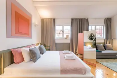 a bedroom with a large bed and a couch at GuestReady - Charming Studio in Porto! in Porto