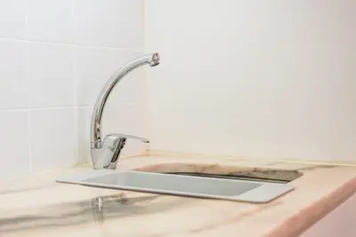 a kitchen sink with a faucet on a counter at GuestReady - Charming Studio in Porto! in Porto