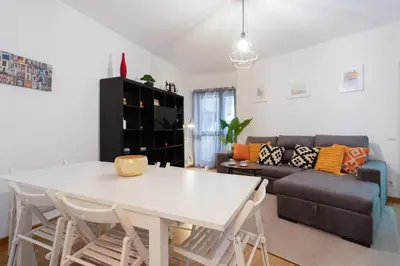 a living room with a table and a couch at Renovated 3BR Apt Near City Hotspots with Great Value in Porto