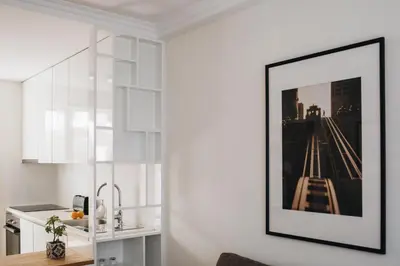a kitchen with a picture of a bridge on the wall at Cozy 1-Bedroom with Private Terrace in Palmela in Porto