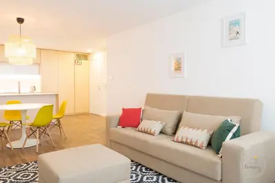 a living room with a couch and a table at Oporto Ceuta Residences - Residence 1 by We Do Living in Porto