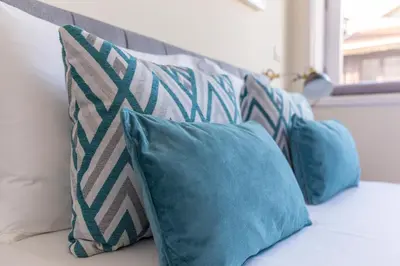 a group of pillows sitting on top of a couch at Oporto Between Walls by the center with A/C in Porto