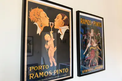 a pair of framed posters on a wall at Oporto Between Walls by the center with A/C in Porto