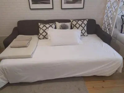 a large bed with white sheets and pillows on it at Oporto Golden View Vitória in Porto