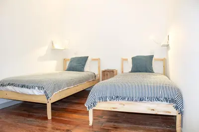 two beds sitting next to each other in a room at Bonjardim Flats - T1 in Porto