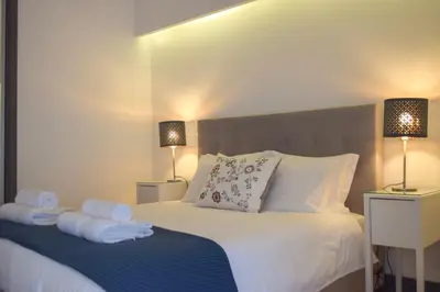 a bedroom with a bed with towels on it at Suite In in Porto