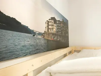 a bedroom with a large picture on the wall at Clérigos Apartments in Porto