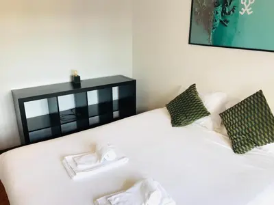 a white bed with two towels on top of it at Clérigos Apartments in Porto