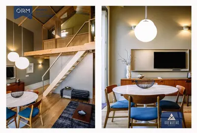 a living room and dining room with a table and a tv at ORM - Almada Terrace Apartment in Porto