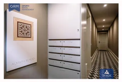 a walk in closet with drawers and a painting on the wall at ORM - Almada Terrace Apartment in Porto