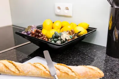 a bowl of fruits and vegetables on a counter with a sandwich at Opo Arte Apartment with terrace and A/C in Porto