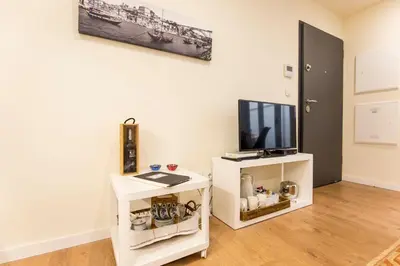 a living room with a tv and a white cabinet at Opo Arte Apartment with terrace and A/C in Porto