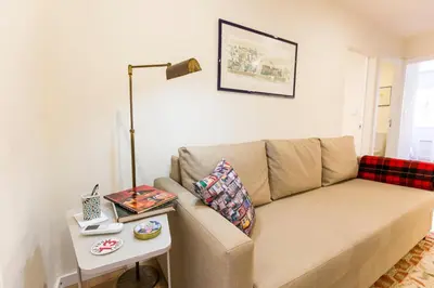 a living room with a couch and a table at Opo Arte Apartment with terrace and A/C in Porto