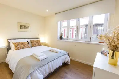 a bedroom with a bed with towels on it at Opo Arte Apartment with terrace and A/C in Porto
