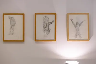 three drawings of people hanging on a wall at Vale71house in Porto
