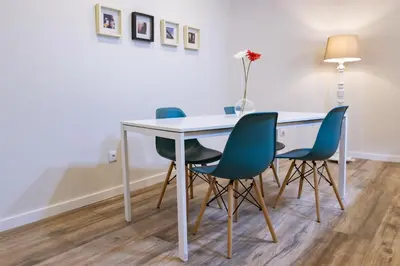 a dining room table with four chairs and a lamp at Vale71house in Porto