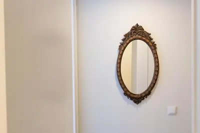 a mirror hanging on a wall next to a door at Vale71house in Porto