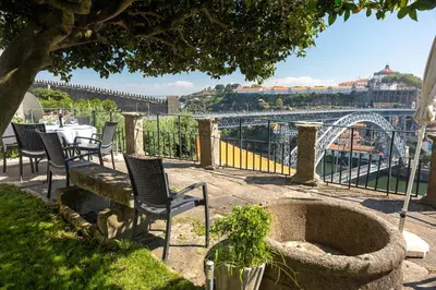 a patio with chairs and a view of a bridge at Manor House Porto in Porto