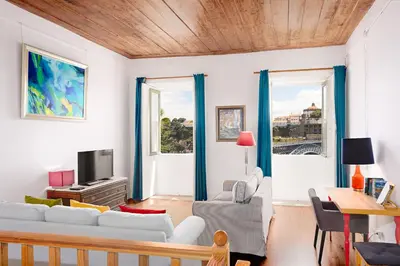 a living room with white furniture and blue curtains at Manor House Porto in Porto