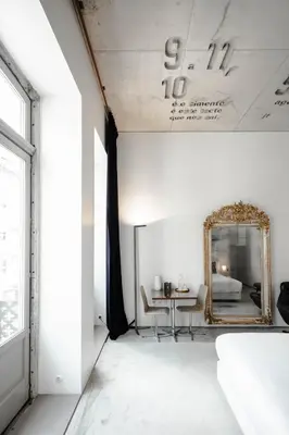 a bedroom with a mirror and a bed at Casa do Conto - Arts & Residence in Porto