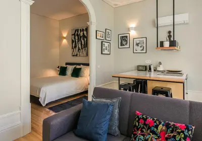 a living room with a couch and a bed at Visconde Garden in Porto