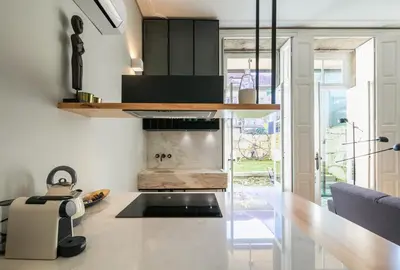 a kitchen with a counter top and a table at Visconde Garden in Porto