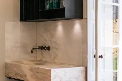 a marble sink in a bathroom with a shower at Visconde Garden in Porto