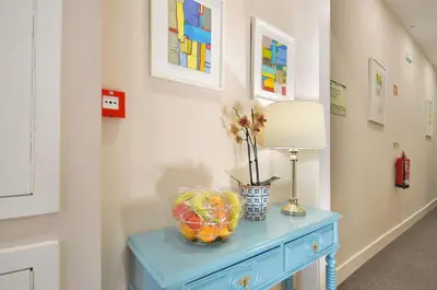 a blue table with a lamp and a bowl of fruit on it at Porto Charming Hotel in Porto
