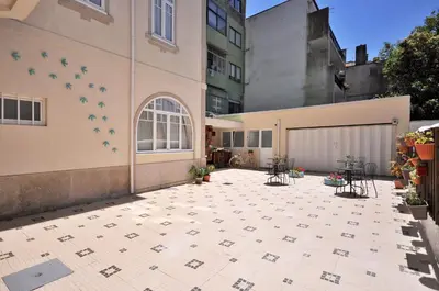 a courtyard with tables and chairs on a building at Porto Charming Hotel in Porto