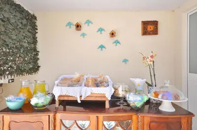 a room with a table with bread and birds on the wall at Porto Charming Hotel in Porto