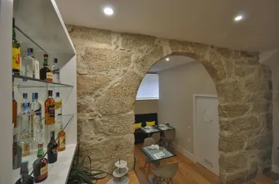 an archway in a room with a stone wall at Porto Charming Hotel in Porto