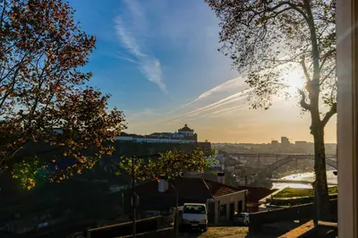 a view of a city with a bridge and a river at Fontainhas River Residence in Porto