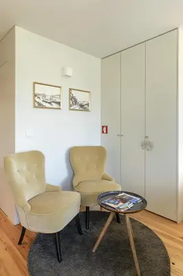 two chairs and a table in a room at Charming City Centre Studio near Aliados - Inside Porto Apartments 