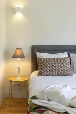 a bedroom with a bed and a lamp on a table at Charming City Centre Studio near Aliados - Inside Porto Apartments 