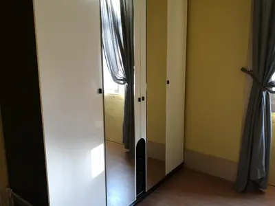 a mirror in the corner of a room with a window at Guesthouse Monsanto in Porto