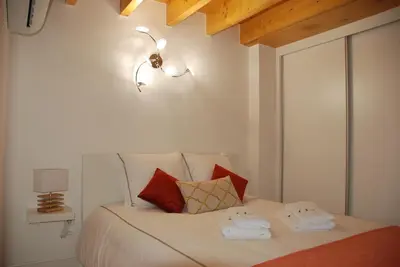 a bedroom with a white bed with red pillows at OportoView Premium Apartment in Porto