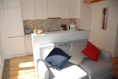 a living room with a couch with pillows on it at OportoView Premium Apartment in Porto