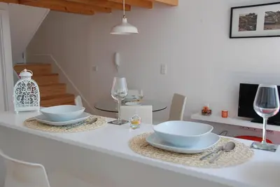 a white table with two bowls and wine glasses on it at OportoView Premium Apartment in Porto