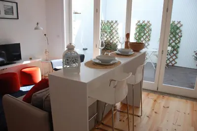 a living room with a table with bowls on it at OportoView Premium Apartment in Porto
