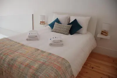 a bedroom with a bed with towels on it at OportoView Premium Apartment in Porto