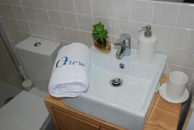a bathroom sink with a towel with the worderror on it at OportoView Premium Apartment in Porto