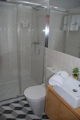 a bathroom with a shower and a toilet and a sink at OportoView Premium Apartment in Porto