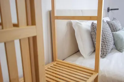 a wooden bunk bed with white pillows on it at Formosa 79 Apartments by Guestify in Porto