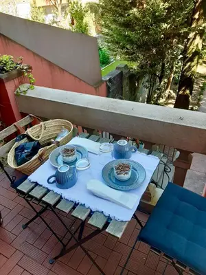 a table with plates and bowls of food on a patio at GR Suites in Porto