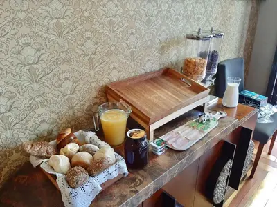 a table with a tray of bread and orange juice at GR Suites in Porto