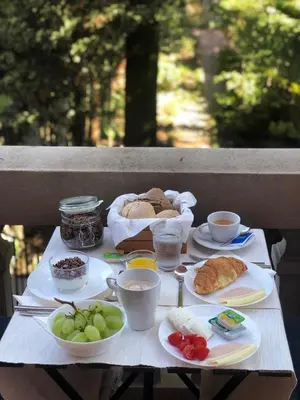 a table with plates of food on top of it at GR Suites in Porto